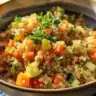 Colorful veggie quinoa dish with fresh vegetables and spices