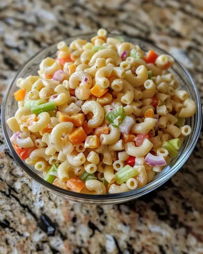 Bowl of creamy Amish Macaroni Salad with vegetables and pasta