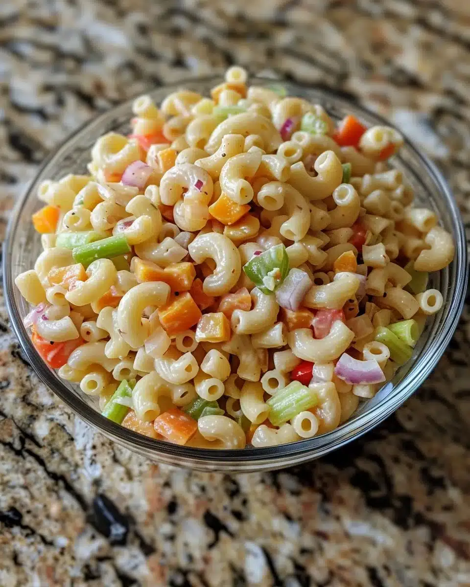Bowl of creamy Amish Macaroni Salad with vegetables and pasta