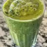 Banana Spinach Smoothie in a glass with fresh ingredients
