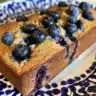 Loaf of homemade blueberry muffin bread with fresh blueberries