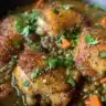 A delicious plate of chicken and lentils, garnished with herbs and spices.