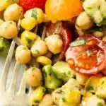 Colorful chickpea salad with vegetables and herbs in a bowl.