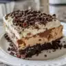 Sliced Chocolate Mocha Cream Pie topped with whipped cream and chocolate shavings
