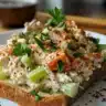 Bowl of classic chicken salad with fresh ingredients and herbs