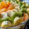 Creamy fruit salad with fresh fruits in a yogurt dressing