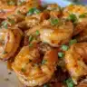 Crispy honey-glazed shrimp served on a plate with garnishments