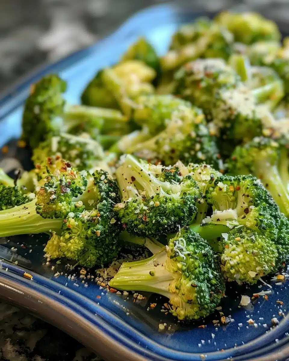 Crispy air fryer broccoli served in a bowl with seasoning and lemon