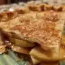 Slice of Granny Smith Apple Pie with a flaky crust and apples