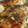 Juicy grilled chicken breasts served with fresh vegetables and herbs