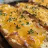 Homemade cheddar cheese crackers served on a wooden board.