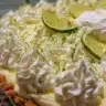 Delicious Key Lime Pie topped with cream cheese for a tangy dessert experience
