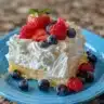 Lemon Berry Yogurt Cake topped with fresh berries and lemon zest