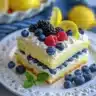 Lemon Berry Yogurt Cake topped with fresh berries and lemon zest