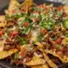Delicious loaded nachos with cheese, jalapeños, and toppings