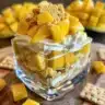 Delicious layered Mango Float dessert with fresh mango slices and cream