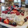 No Bake Berry Chantilly Cake topped with fresh berries and whipped cream