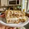 Freshly baked no-knead honey oat bread with golden crust and oats on top
