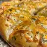 Freshly baked No-Knead Jalapeño Cheddar Bread with melted cheese and jalapeños