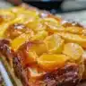 Deliciously golden Peach French Toast topped with fresh peach slices and syrup.