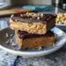 Peanut butter and jam thumbprint cookies on a cooling rack