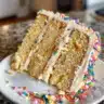Delicious Peanut Butter Vanilla Cake with creamy frosting on a rustic plate
