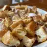 Delicious Pecan French Toast Casserole topped with crunchy pecans and syrup.