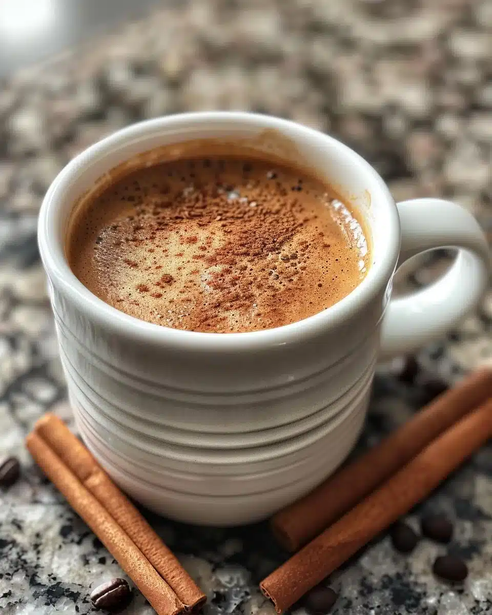A cup of spiced coffee with aromatic spices and steam rising