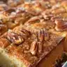 Delicious sticky pecan cinnamon buns garnished with caramel and nuts
