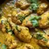 Authentic Jamaican Curry Chicken served with rice and vegetables