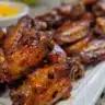 Baked mango habanero chicken wings served on a platter