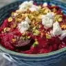 Delicious beet salad topped with creamy goat cheese and fresh greens