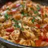 Delicious Cajun chicken served with orzo pasta on a plate.
