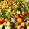 Colorful chickpea salad with fresh vegetables and herbs