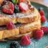 Delicious cinnamon-maple brioche toast served on a plate with syrup drizzle