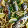 Citrus Garlic Sardine Pasta topped with fresh herbs and lemon zest