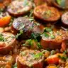 Bowl of comforting lentil soup with andouille sausage and fresh herbs