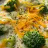 Delicious copycat Panera broccoli cheese soup in a bowl with fresh toppings.