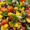 Delicious Corn and Black Bean Salad served in a bowl with fresh ingredients.
