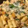 Creamy butternut squash pasta with sausage and spinach in a bowl