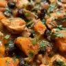 Bowl of creamy pumpkin chicken chili topped with cilantro and pumpkin seeds