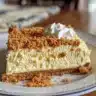 Creamy pumpkin pie cheesecake topped with whipped cream and spices