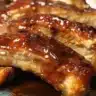 Delicious Crockpot BBQ Chicken simmering in sauce, served on a plate.