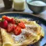 Delicious gluten free crepes served with fresh fruit and syrup