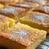 Gluten-free French butter cake served on a plate with a dusting of powdered sugar