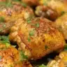 Crispy gluten-free fried chicken on a plate with herbs