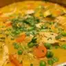 Bowl of golden turmeric chicken soup with fresh herbs for inflammation relief
