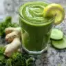 Fresh green juice made from spinach, kale, and apple in a glass.