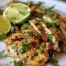 Juicy grilled cilantro lime chicken garnished with fresh herbs.
