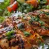 A delicious honey-glazed harissa chicken bowl with colorful vegetables and grains